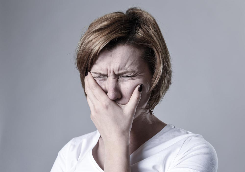 depressed woman suffering from toothache